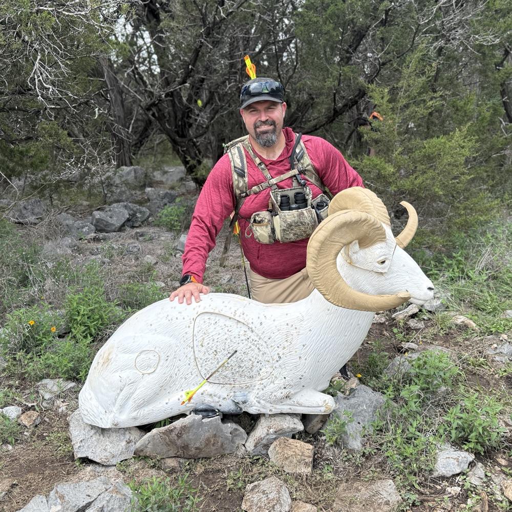 Mark Wolfe, owner of Archery Nomad, with a 3D ram target on an outdoor archery range
